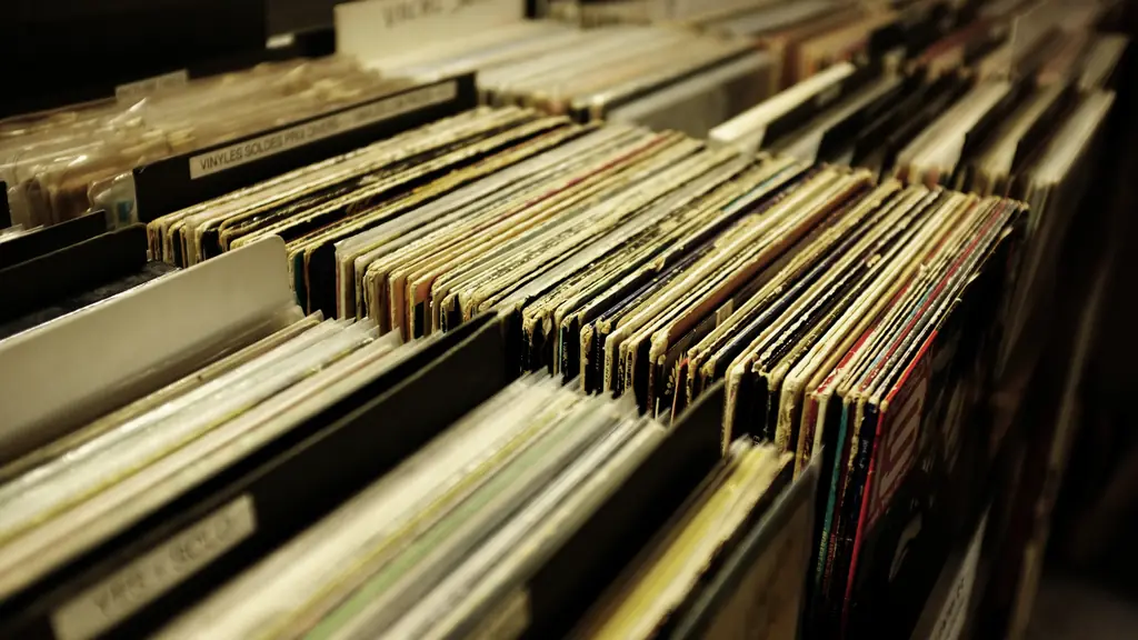 Rows of record sleeves standing in warmly lit bins, seen at an angle.
